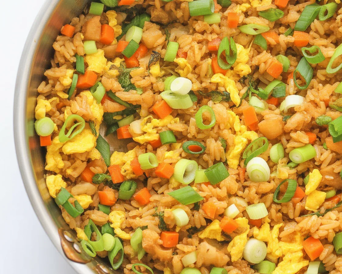 Delicious vegetable fried rice with colorful veggies in a serving bowl.
